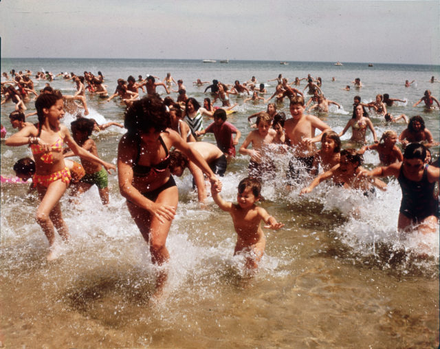 Swimmers run out of the water in a scene from Jaws