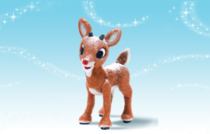 Model of Rudolph the Red-Nosed Reindeer in front of a blue background with snow.