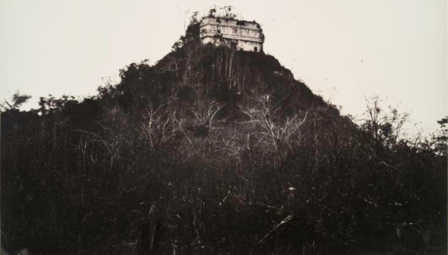 The abandoned temple of Kukulcan in 1860 covered in brush 