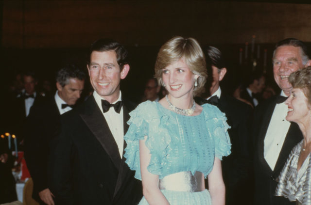 Then-Prince Charles and Diana, Princess of Wales standing among a crowd of people