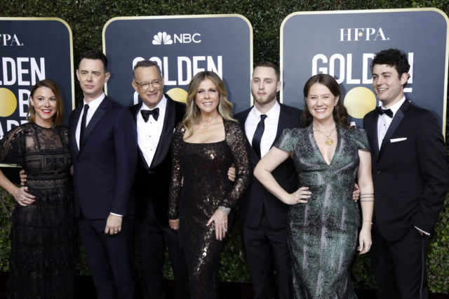 The members of the Hanks family standing on a red carpet.