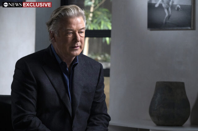 Alec Baldwin sitting in a chair