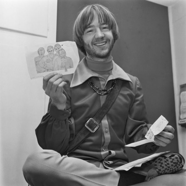 Peter Tork holding up a drawing