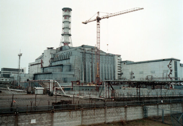 Sarcophagus over Chernobyl power plant's fourth reactor, with a crane beside it.
