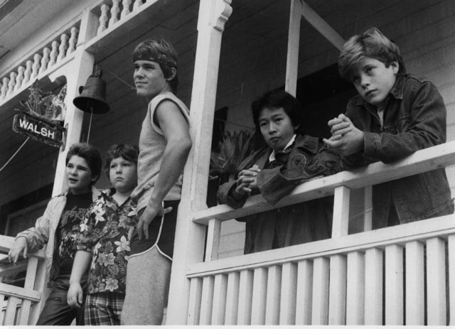 The Goonies cast hanging out in front of a house