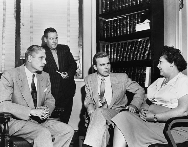 Nannie Doss sits with Al Locke, Wayne Owens, and J. Howard Edmondson while they question her.