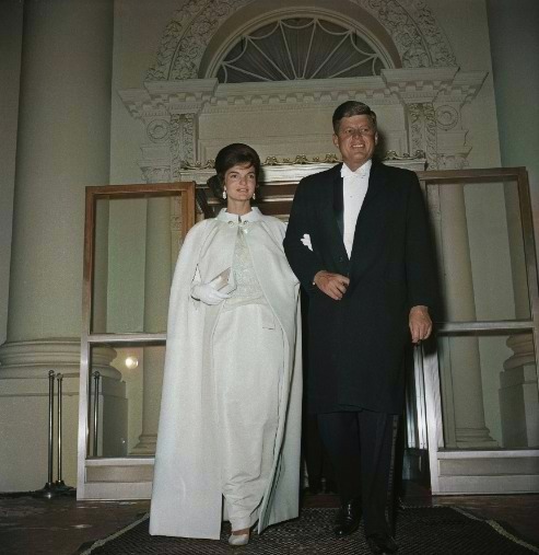 Jackie and John Kennedy in fancy dress arm in arm