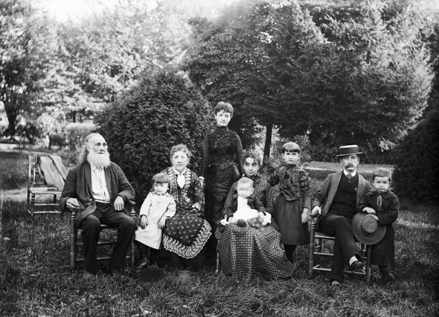Victorian family sitting together in a garden