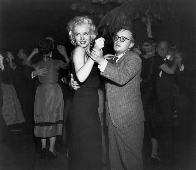 Truman Capote dancing with Marilyn Monroe