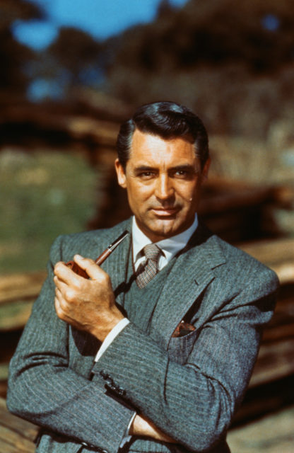 Headshot of Cary Grant holding a pipe