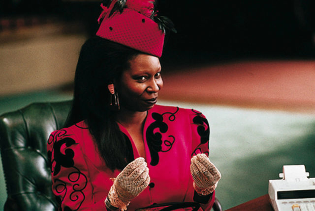 Whoopi Goldberg at Oda Mae Brown in 'Ghost' holding her hands up gesturing money.