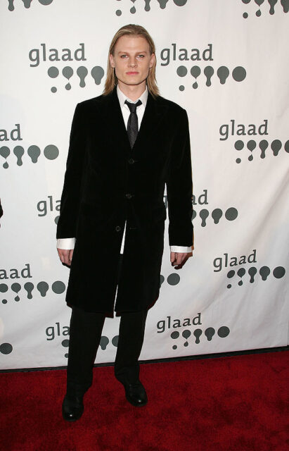 Jeffrey Carlson standing on a red carpet