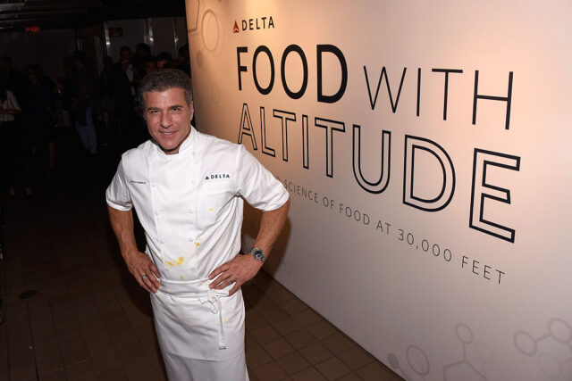 Michael Chiarello standing in front of a sign that says "FOOD WITH ALTITUDE"