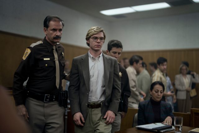 A still from Monster: The Jeffrey Dahmer Story shows Dahmer being walked into court