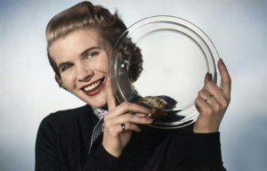 Woman holding up a glass pyrex dish.