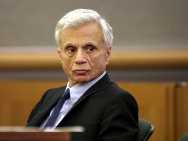Robert Blake sitting in a courtroom chair