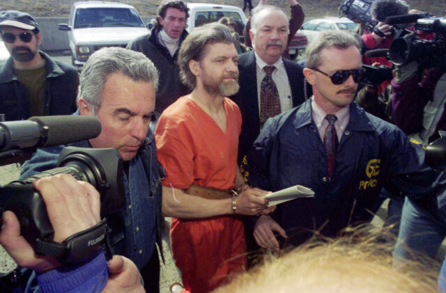 Ted Kaczynski surrounded by federal marshals