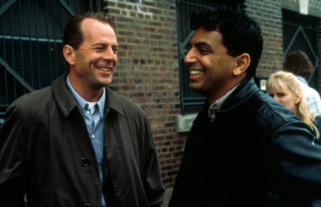 Behind the scenes photo of Bruce Willis and M. Night Shyamalan
