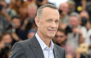 Headshot of Tom Hanks with blurry people in the background