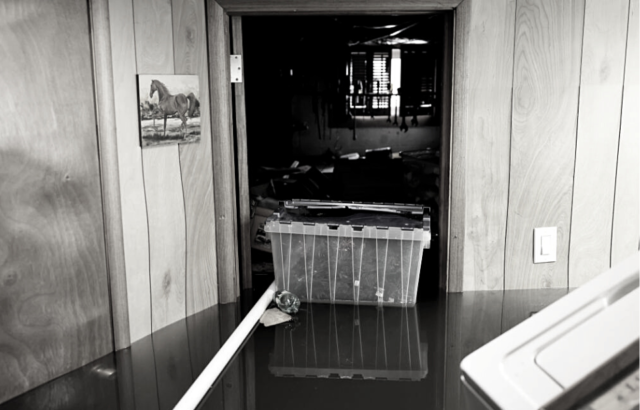 A storage tote floats in a flooded basement, stock photo