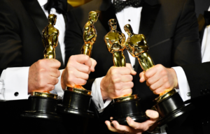 Four men holding Oscar statuettes