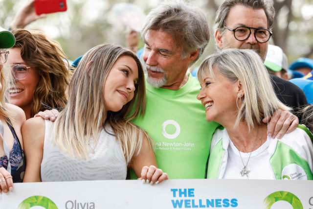 Photo of Chloe Lattanzi, John Easterling, and Olivia Newton-John at a cancer research event in 2019.