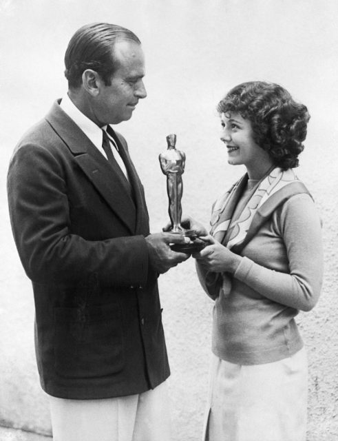 Douglas Fairbanks Sr. presenting Janet Gaynor an Academy Award.