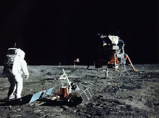 Astronaut Edwin E. Aldrin Jr stands near a scientific equipment on the moon.