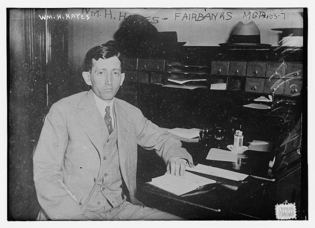 Will H Hayes in a portrait taken in front of his desk