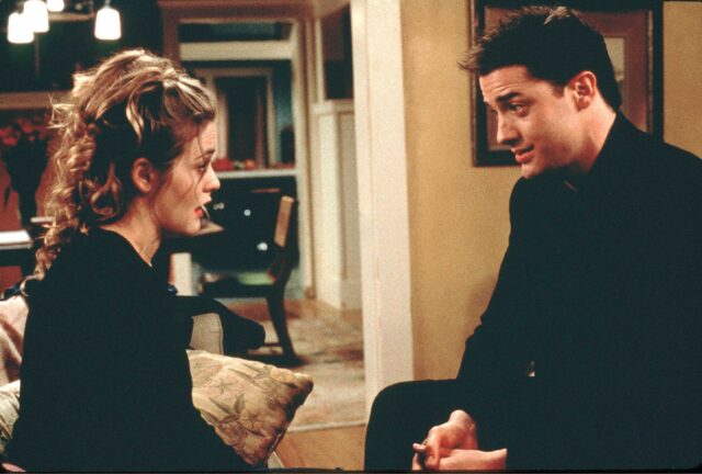 Alicia Silverstone and Brendan Fraser sitting across from one another in a scene from 'Blast From the Past'
