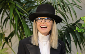 Headshot of Diane Keaton smiling, wearing a hat.