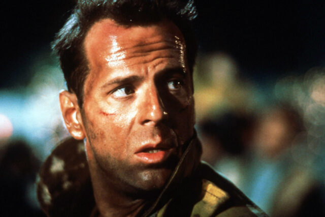 Headshot of Bruce Willis in a scene from 'Die Hard'.