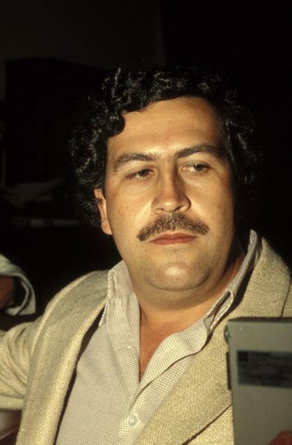 Headshot of Pablo Escobar looking to his left.