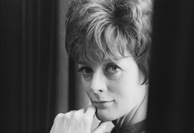 English actress Maggie Smith is seen looking over her shoulder in a black and white image