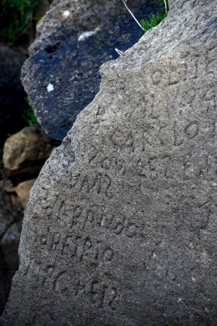inscriptions composing indecipherable words on the rock