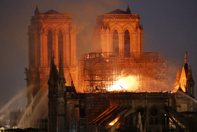 A view of fire at the back of the Notre Dame cathedral at night.
