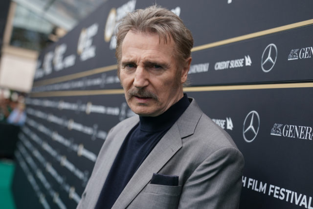 Headshot of Liam Neeson with a moustache.