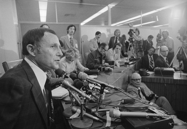 Daryl Gates given a press conference about the Hillside Strangler while surrounded by reporters. 