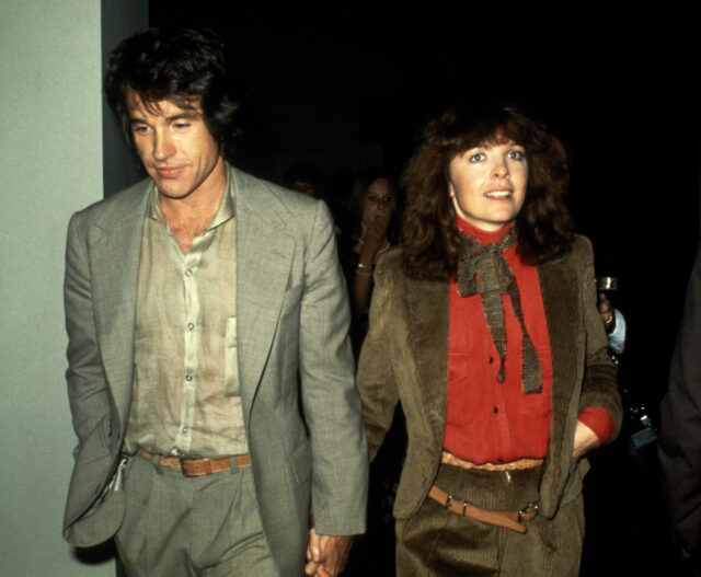 Diane Keaton and Warren Beatty walking together, holding hands.