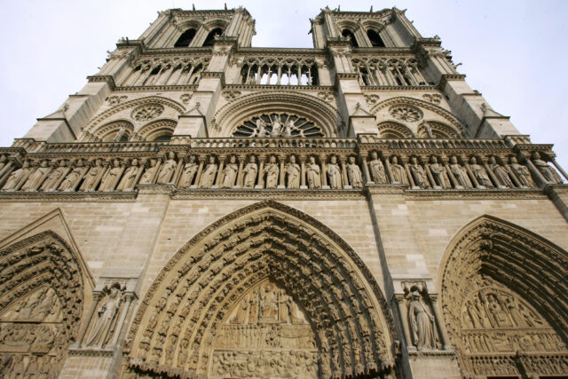 A bottom-up view of the front of Notre Dame cathedral.