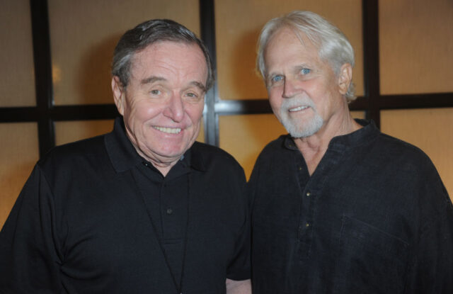 Jerry Mathers and Tony Dow in black t-shirts pose together.