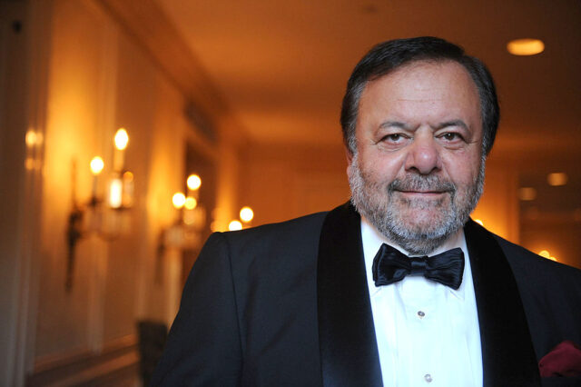 Paul Sorvino in a black suit and bow tie. 