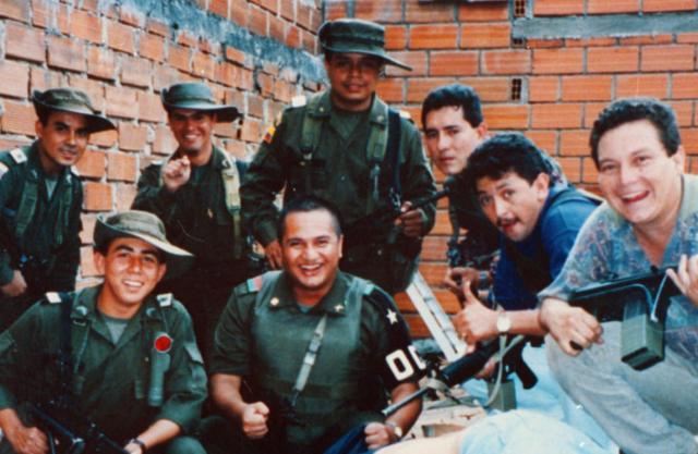 Several Search Bloc officers smiling for a photo. One holds a gun.