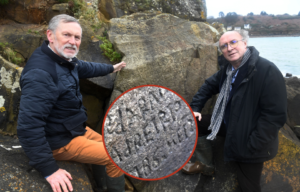 Two men stand beside a stone with etchings carved into it, a close-up photo of those etchings beneath it.