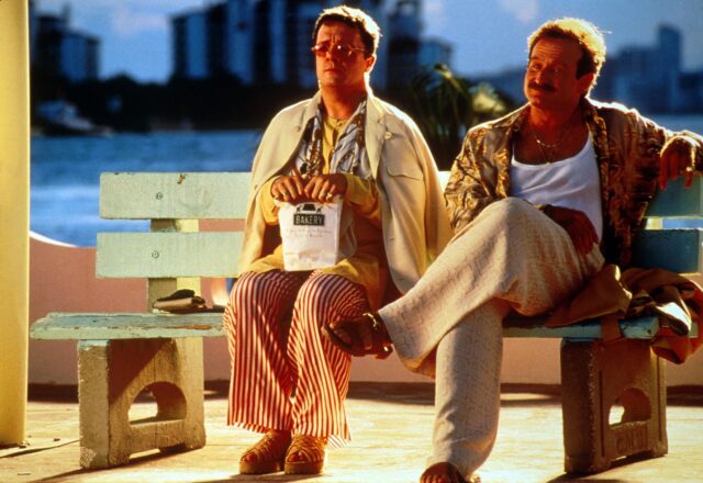 Robin Williams and Nathan Lane sitting on a public bench in a scene from 'The Birdcage'