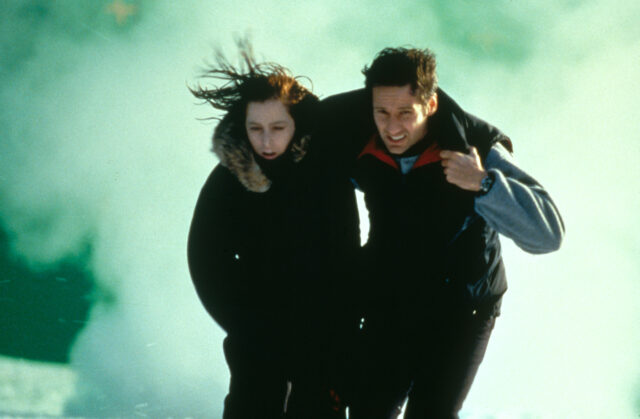 David Duchovny helping a frostbitten Gillian Anderson walk.