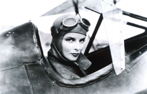 Katharine Hepburn sitting in the cockpit of an aircraft