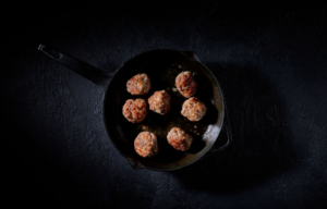 Seven meatballs in a cast iron pan