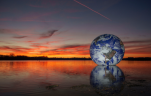 The sun sets behind artist Luke Jerram's 'Floating Earth' at Pennington Flash on November 22, 2021 in Wigan, England.