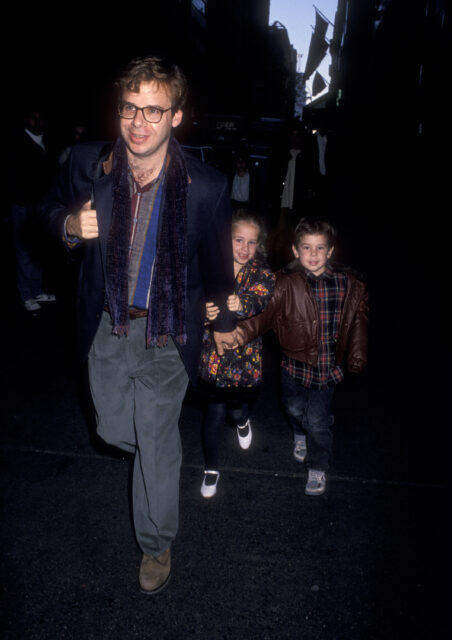 Rick Moranis walking with his two children